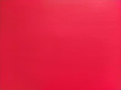 abstract red background or Christmas paper texture. Red base for cards for Valentine's Day, New Year, or Christmas. Color gradient.