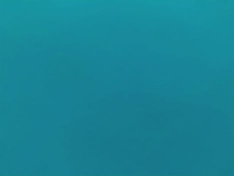 Background from colored paper. Wallpaper texture detail background in shiny cyan blue green turquoise color.