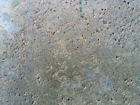 Concrete wall with concentric damage of large radius. Potholes, tubercles and defects. Gray, brown and beige colors. Planet surface concept. Concrete wall with a worn surface, potholes and stones
