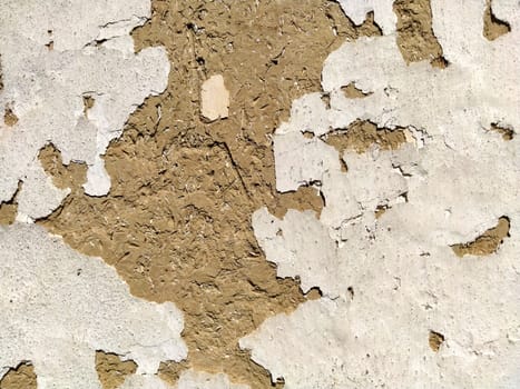 Close-up background of the wall of an old house made of clay mixed with straw. Old type of construction. Clay wall of straw and mud. Manure mixed with clay and dried as building material.