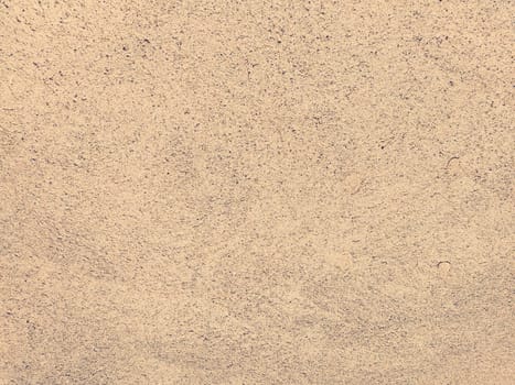 Concrete background of beautiful natural color of crushed stone. Fine ripples of ground sand and gravel. beige color. The background. Copy space.