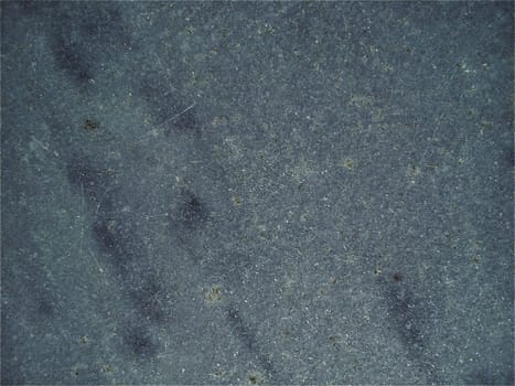 Granite smooth surface or slab of languid gray color with black spots and dots. Variant of interior decoration. Close-up. Natural background. Stone cutting.
