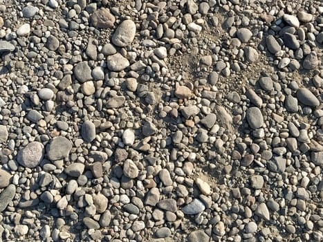 Grey stones background. gray stones. Small and large crushed stone. Natural background.