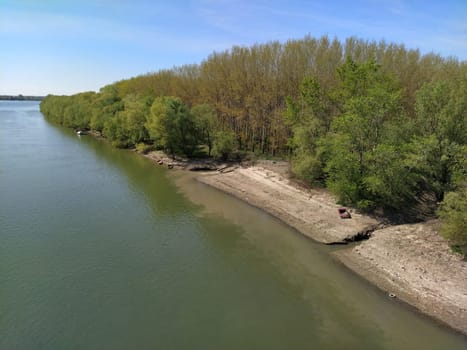 A large city drain drains sewage into a canal that flows into the river. Ecological problem. The concept of environmental protection and ecology. Colorful water in the pond. Nature pollution.