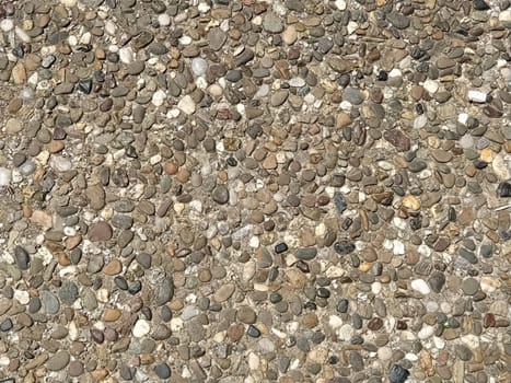 assorted colorful and smooth pebbles from the beach.