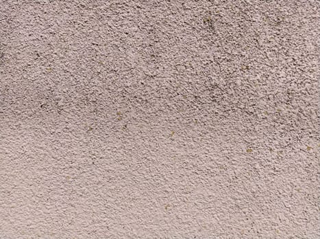 Uneven rough pink concrete wall. Background or texture.