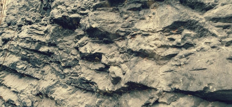 Stone rock close up. Ancient frozen lava. Layers and strata of rocks. The texture of gray stone. Natural colors. Bosnia and Herzegovina, Sarajevo. Career development.