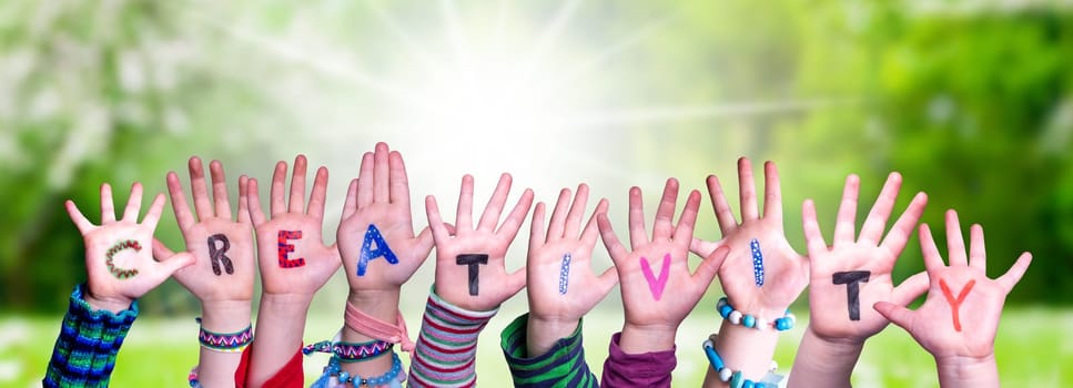 Children Hands Building Colorful English Word Creativity. Sunny Green Grass Meadow As Background.