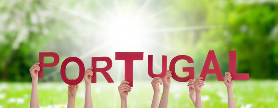 People Or Persons Hands Building English Word Portugal. Sunny Green Grass Meadow As Background.