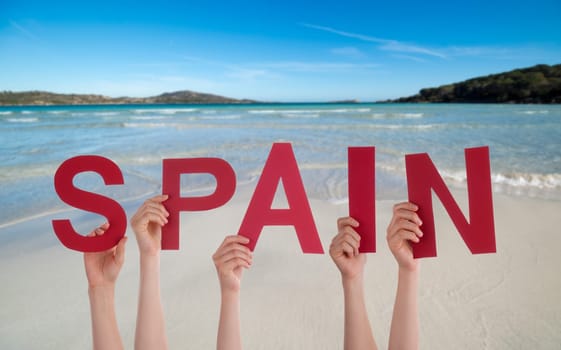 People Or Persons Hands Building English Word Spain. Summer Ocean, Sea And Beach As Background.