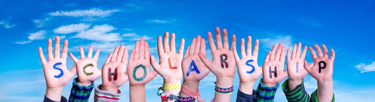 Children Hands Building Colorful English Word Scholarship. Blue Sky As Background.