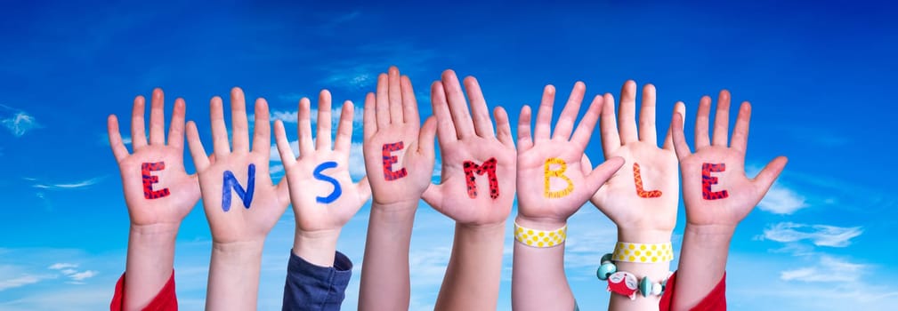 Children Hands Building Colorful English Word Ensemble. Blue Sky As Background