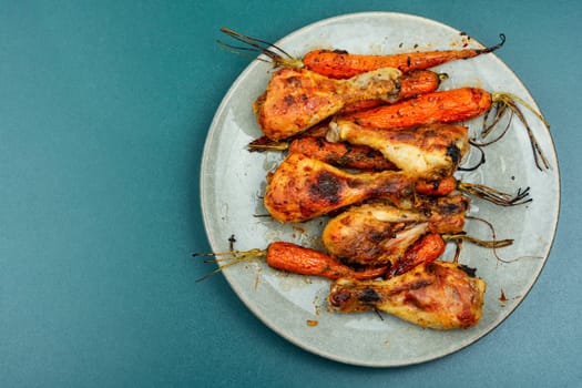 Grilled chicken drumsticks, roast chicken legs with carrots. Space for text.