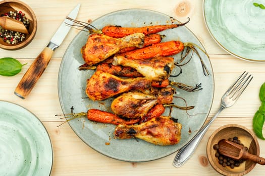 Grilled chicken drumsticks, roast chicken legs with carrots. Space for text.