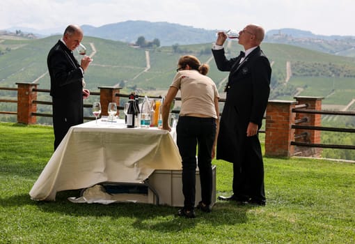 Grinzane Cavour, Italy - Sept 8, 2022: Elegantly dressed sommeliers during a wine tasting in the garden of Grinzane Cavour Castle, Langhe region, Piedmont, Italy