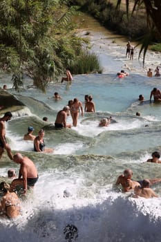 Saturnia, Italy - September 13, 2022:  People are bathing in the hot springs of Saturnia Therme, Saturnia, Tuscany, Italy