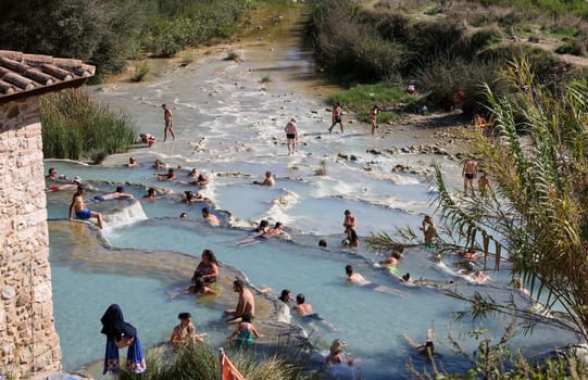 Saturnia, Italy - September 13, 2022:  People are bathing in the hot springs of Saturnia Therme, Saturnia, Tuscany, Italy
