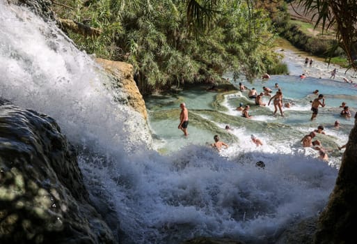 Saturnia, Italy - September 13, 2022:  People are bathing in the hot springs of Saturnia Therme, Saturnia, Tuscany, Italy