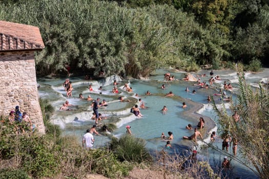 Saturnia, Italy - September 13, 2022:  People are bathing in the hot springs of Saturnia Therme, Saturnia, Tuscany, Italy