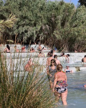 Saturnia, Italy - September 13, 2022:  People are bathing in the hot springs of Saturnia Therme, Saturnia, Tuscany, Italy