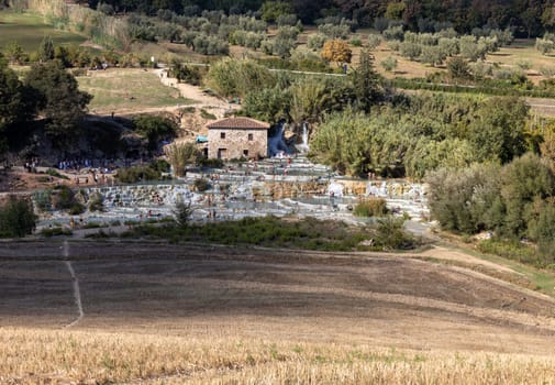 Saturnia, Italy - September 13, 2022:  People are bathing in the hot springs of Saturnia Therme, Saturnia, Tuscany, Italy
