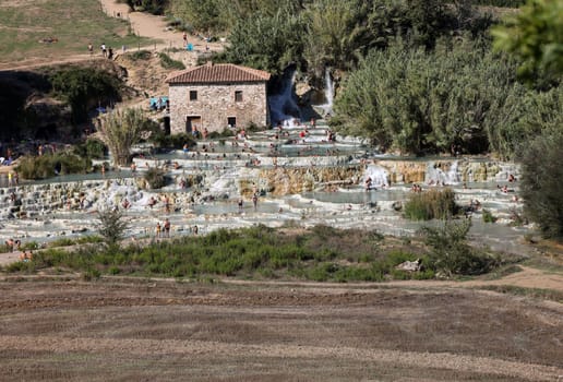 Saturnia, Italy - September 13, 2022:  People are bathing in the hot springs of Saturnia Therme, Saturnia, Tuscany, Italy