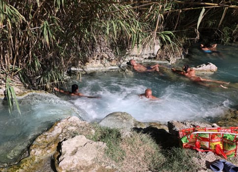 Saturnia, Italy - September 13, 2022:  People are bathing in the hot springs of Saturnia Therme, Saturnia, Tuscany, Italy