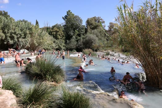 Saturnia, Italy - September 13, 2022:  People are bathing in the hot springs of Saturnia Therme, Saturnia, Tuscany, Italy