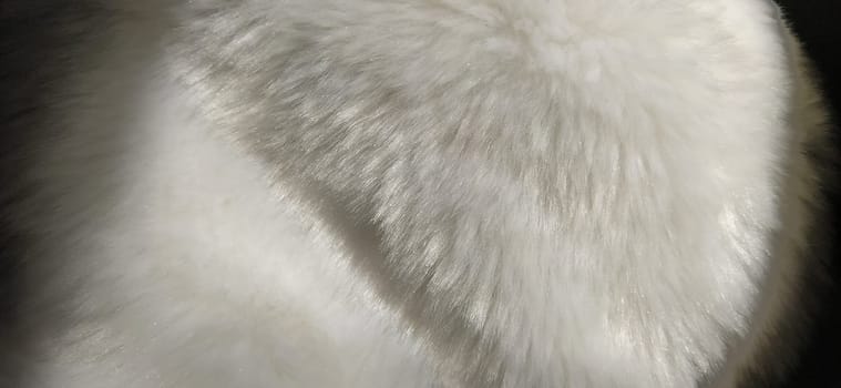 White faux fur. Close-up. Partially defocused photo. Fluffy villi.
