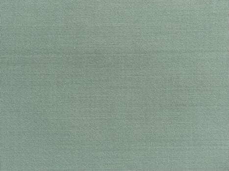 light green fabric. A piece of woolen fabric laid out neatly on the surface. Interlacing and textile texture. dress fabric or for kitchen needs, tablecloth or curtains.