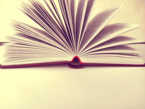the opened book on the white table. Vanilla yellow nuance