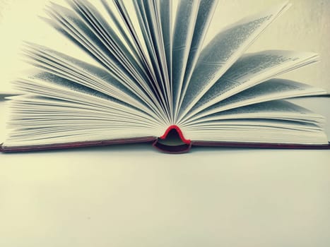 the opened book on the white table.
