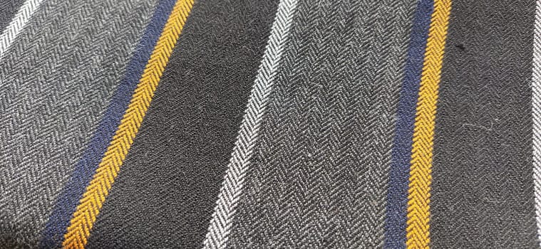 Light fabric with orange and dark blue stripes. Interior decoration. Dress fabrics in casual style. Dense material for indoor curtains and furniture finishing.