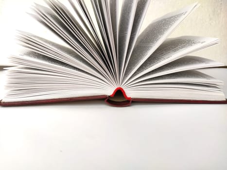 the opened book on the white table.