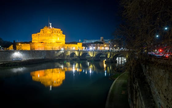 Sant' Angelo Bridge and Basilica of St. Peter at night in Rome, Italy