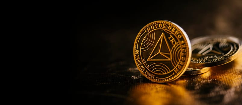 Closeup of golden tron coin TRX cryptocurrency over black and gold background. Virtual money altcoin and blockchain concept.