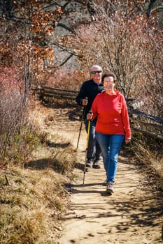 Senior couple is hiking in the woods in North Carolina in fall