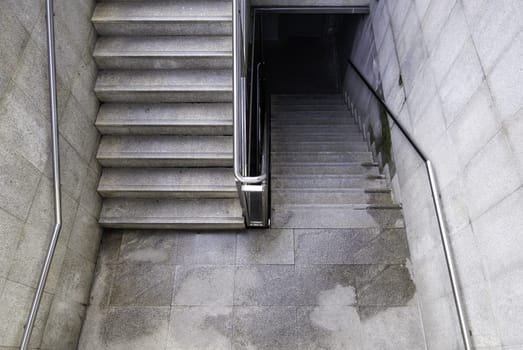Detail of access stairs for pedestrians in a street in the city, access to the subway
