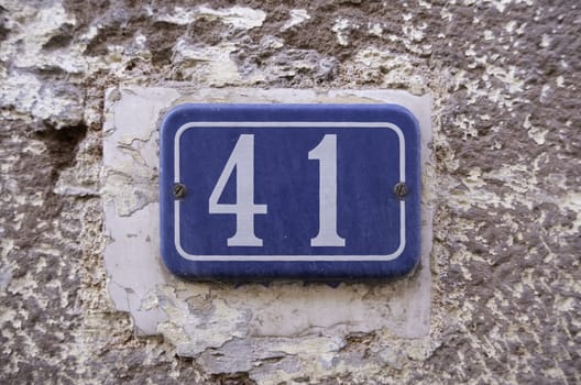 Detail of old odd number of information on a street in a town, address