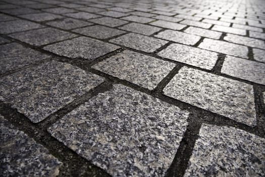 Detail of old handmade stone flooring for pedestrians