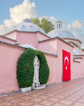 Hagia Sophia Hurrem Sultan Bathhouse, or Ayasofya Hurrem Sultan Hamami, a historic traditional ottoman Turkish bath, with marble water fountain and Turkish flag, Sultanahmet Square, Istanbul, Turkey