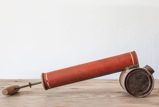 Old rusty manual spray pump for insecticides. Country style background