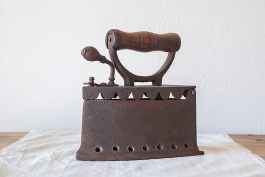 Old rusty charcoal iron. Country style background