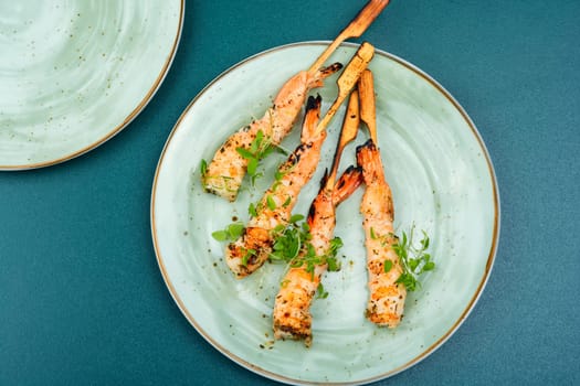 Classic shrimp or langoustines barbecue with herbs grilled on wooden sticks. Top view