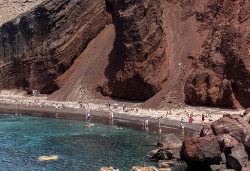 Santorini, Greece - July 01, 2021: The famous Red beach on the south coast of Santorini island, Cyclades, Aegean Sea.