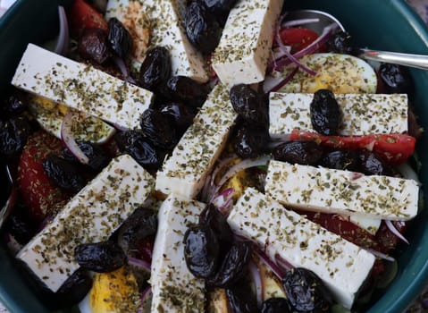 Greek salad with feta cheese and black olives. Typical delicious greek style lunch
