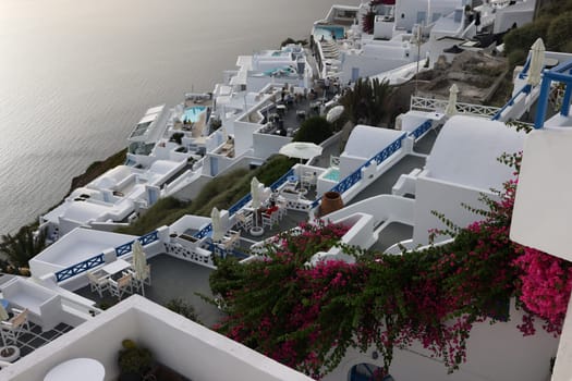 Imerovigli, Santorini, Greece - July 1, 2021: Whitewashed houses with terraces and pools and a beautiful view in Imerovigli on Santorini island, Greece