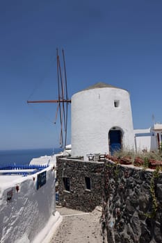 Traditional white windmill in Oia on the island of Santorini. Cyclades, Greece