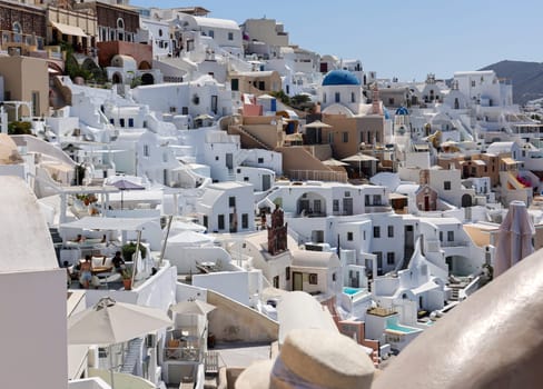 Oia, Santorini, Greece - July 3, 2021: Whitewashed houses in Oia on Santorini island, Cyclades, Greece