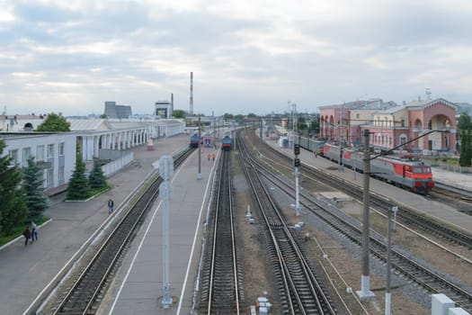Railway station. Trains, platform, wagons, people.